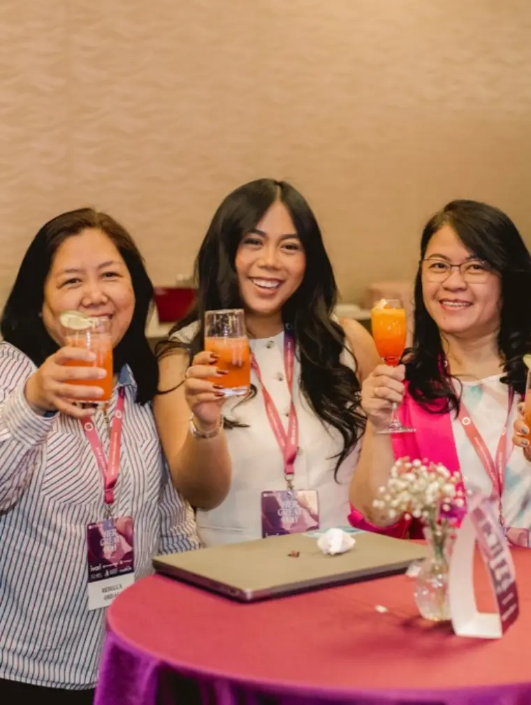 Guests smiling together holding handcrafted Club Citrine mocktails
