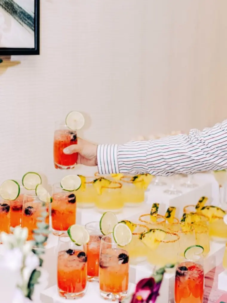 Two guests toasting with zero-proof Club Citrine mocktails