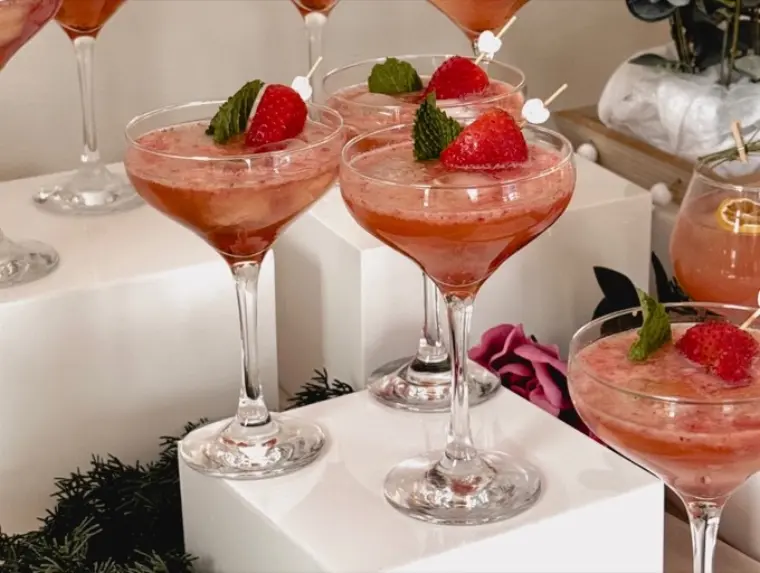 An elegant white mocktail bar styled with florals for a wedding